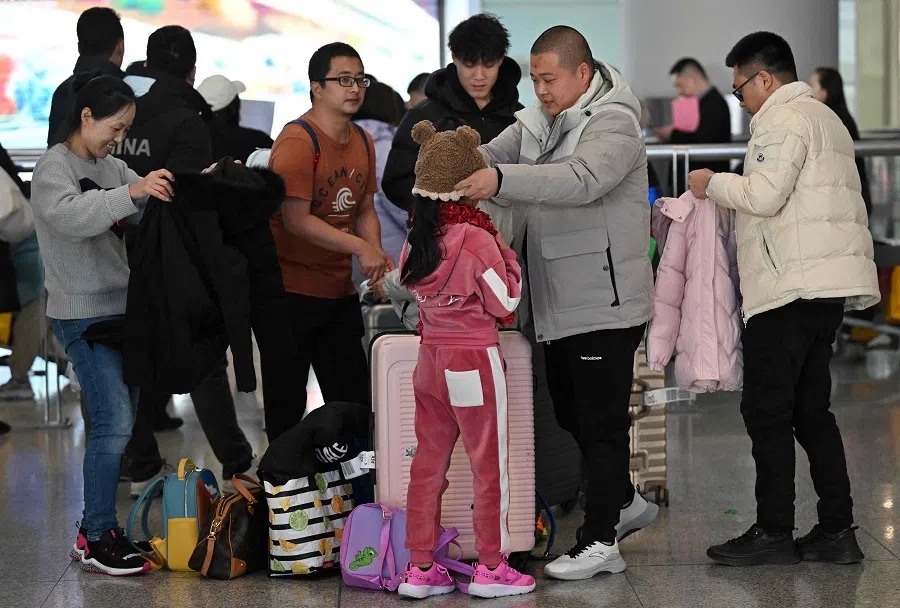 Passengers arrive at Beijing Capital International Airport in Beijing, China, on 8 January 2025. (Adek Berry/AFP)