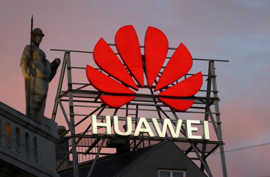 The logo of the Chinese telecommunications giant Huawei Technologies is pictured next to a statue on top of a building in Copenhagen, Denmark, 23 June 2021. (Wolfgang Rattay/Reuters)
