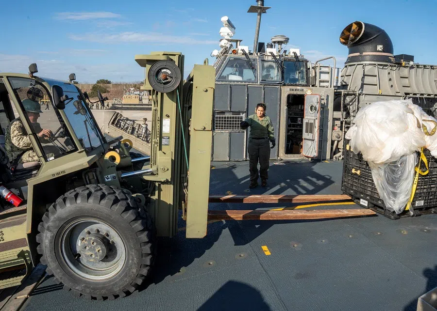 US Navy sailors assigned to Assault Craft Unit 4 prepare material recovered in the Atlantic Ocean from a high-altitude Chinese balloon shot down by the US Air Force off the coast of South Carolina for transport to federal agents at Joint Expeditionary Base-Little Creek after docking in Virginia Beach, Virginia, US, on 10 February 2023 in this image released by the US Navy in Washington, US, 13 February 2023. (Mass Communication Specialist 1st Class Ryan Seelbach/US Navy/Handout via Reuters)