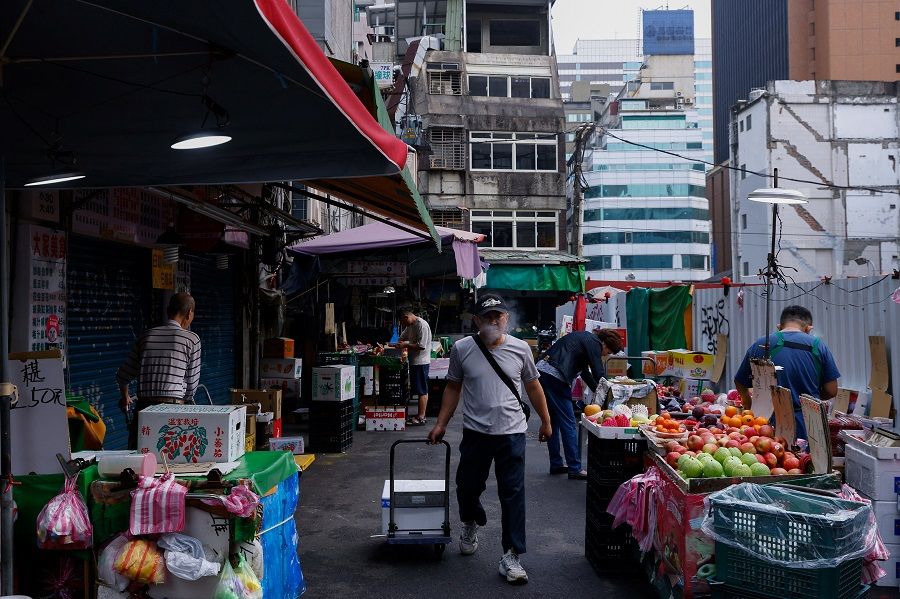 Vendors get ready for the morning market in Taipei, Taiwan, 6 April 2023. (Ann Wang/Reuters)