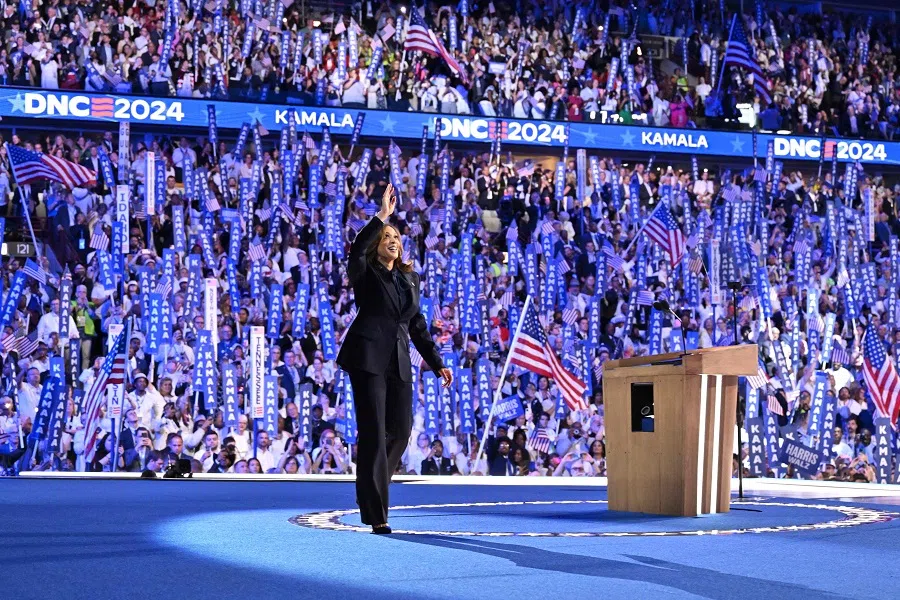 US Vice-President and 2024 Democratic presidential candidate Kamala Harris waves as she arrives onstage to speak at the Democratic National Convention (DNC) at the United Center in Chicago, Illinois, on 22 August 2024. (Robyn Beck/AFP)