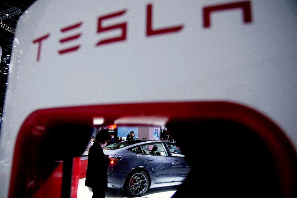 A Tesla electric vehicle is seen through a charging point displayed during a media day for the Auto Shanghai show in Shanghai, China, 20 April 2021. (Aly Song/File Photo/Reuters)