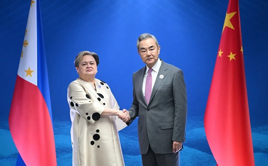 Philippine Foreign Secretary Theresa Lazaro shakes hands with China's Foreign Minister Wang Yi during their bilateral meeting on the sidelines of the ASEAN Foreign Ministers' Meeting in Pasay, Metro Manila, on 22 July 2026.