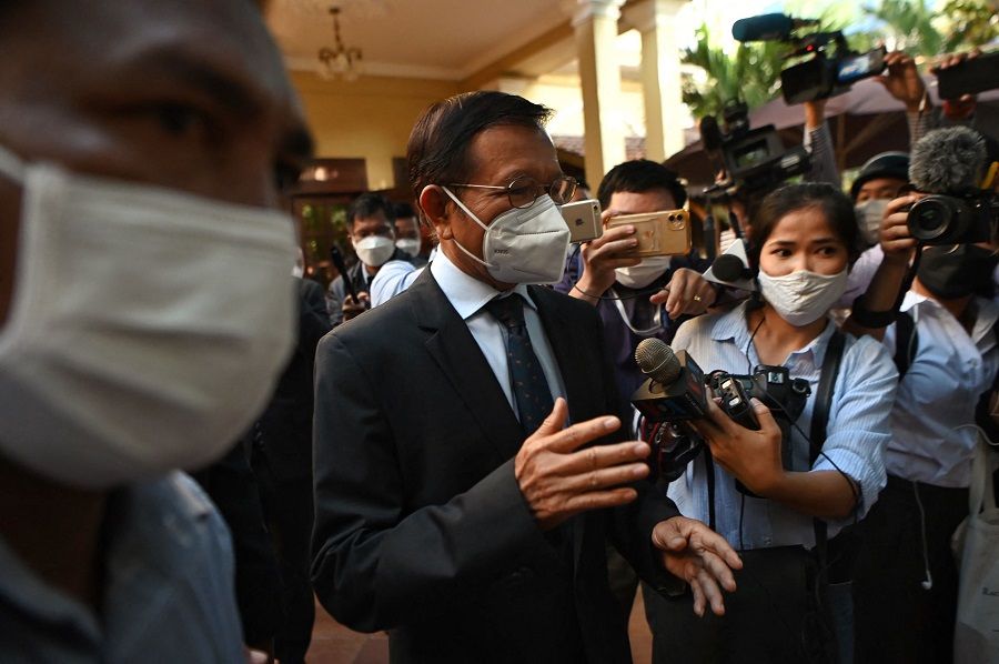 Khem Sokha (centre), former leader of the now-dissolved Cambodia National Rescue Party (CNRP), speaks to the media at his home before going to Phnom Penh Municipal Court for the resumption of his trial on treason charges in Phnom Penh, Cambodia, on 19 January 2022. (Tang Chhin Sothy/AFP)