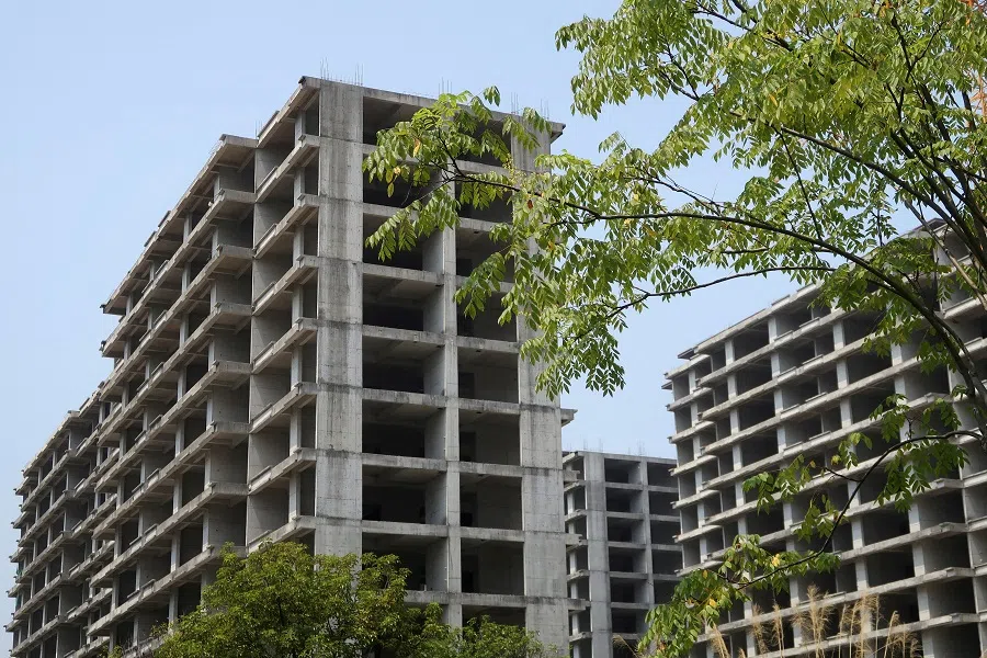 Unfinished apartment buildings stand at a residential complex in Guilin, Guangxi Zhuang Autonomous Region, China, 17 September 2022. (Eduardo Baptista/File Photo/Reuters)
