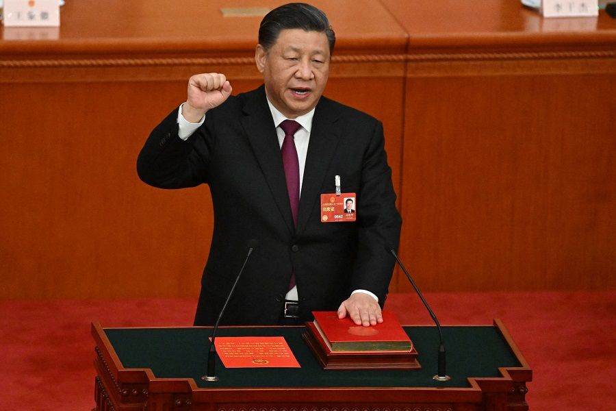 China's President Xi Jinping swears under oath after being re-elected as president for a third term during the third plenary session of the National People's Congress (NPC) at the Great Hall of the People in Beijing, China, on 10 March 2023. (Noel Celis/AFP)