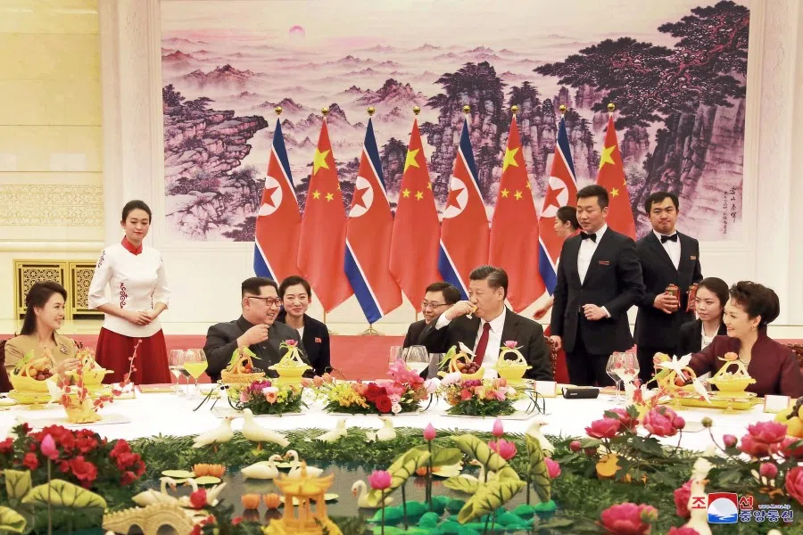 North Korean leader Kim Jong Un and wife Ri Sol Ju, and Chinese President Xi Jinping and wife Peng Liyuan toast each other, as Kim Jong Un paid an unofficial visit to Beijing, China, in this undated photo released by North Korea's Korean Central News Agency (KCNA) in Pyongyang 28 March 2018. (KCNA/via Reuters)