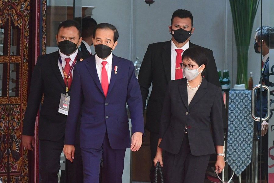 Indonesian President Joko Widodo and Indonesian Foreign Minister Retno Marsudi walk as they attend the ASEAN leaders' summit at the the Association of Southeast Asian Nations (ASEAN) secretariat building in Jakarta, Indonesia, 24 April 2021. (Muchlis Jr/Indonesian Presidential Palace/Handout via Reuters)