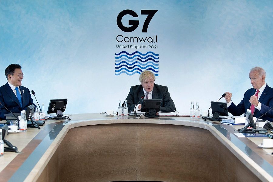 South Korea's President Moon Jae-in (left) and US President Joe Biden (right) listen to Britain's Prime Minister Boris Johnson during a working sesssion at the G7 summit in Carbis Bay, Cornwall on 12 June 2021. (Brendan Smialowski /Pool/AFP)