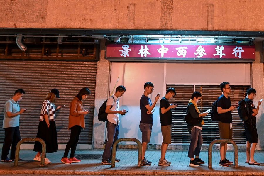 People queue to cast their vote during the district council elections in Tseung Kwan O district in Hong Kong on 24 November 2019. (Ye Aung Thu/AFP)