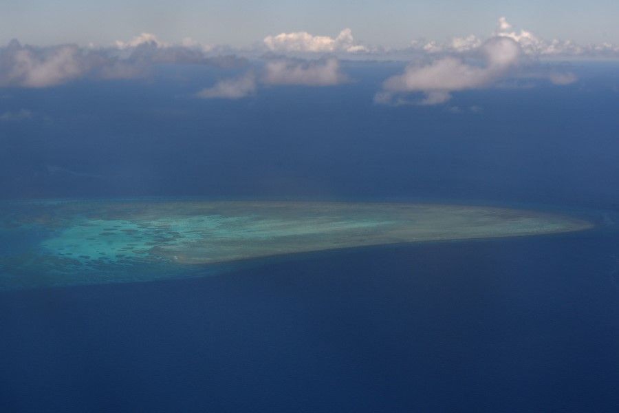 This file photo taken on 21 April 2017 shows an aerial view of a reef near the island of Thitu in the disputed Spratly islands. The United States announced sanctions and restrictions on 24 Chinese companies and associated officials on 26 August 2020 for taking part in building artificial islands in disputed waters in the South China Sea. (Romeo Gacad/AFP)