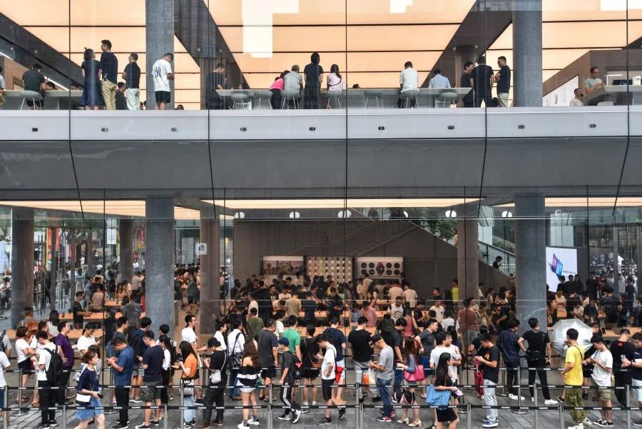 People queueing outside a newly-opened Huawei flagship store in Shenzhen. Huawei has had strong domestic support in the face of the China-US trade war. (AFP)