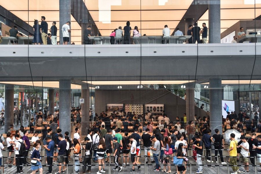 People queueing outside a newly-opened Huawei flagship store in Shenzhen. Huawei has had strong domestic support in the face of the China-US trade war. (AFP)