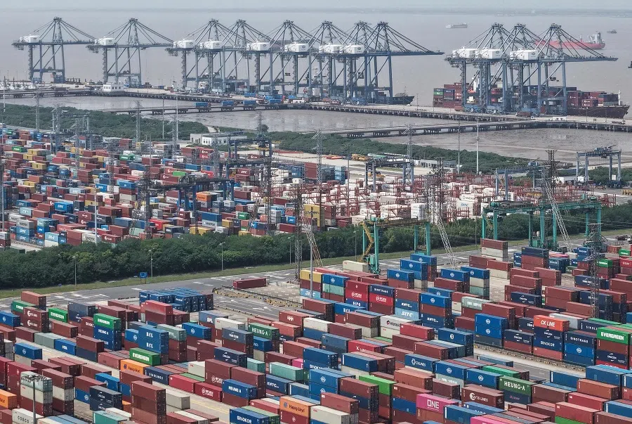 Shipping containers are stacked at a port in Shanghai on 9 May 2025.