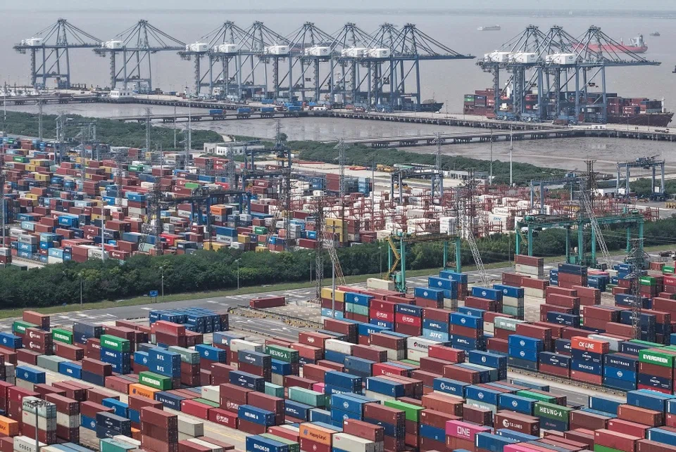 Shipping containers are stacked at a port in Shanghai on 9 May 2025. (AFP)