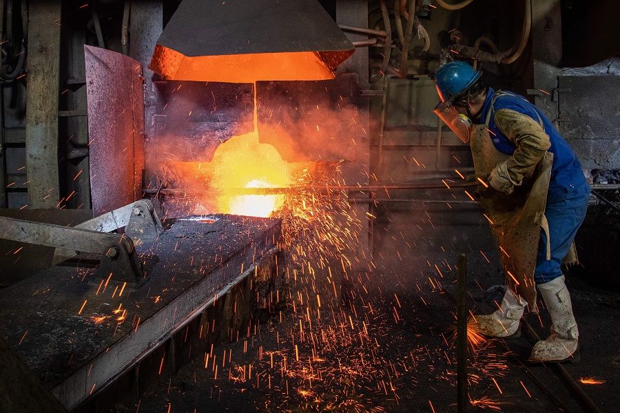 This photo taken on 1 April 2020 shows an employee working at a metal production plant in Huangshi, Hubei, China. (STR/AFP)