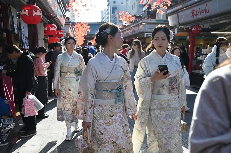Three Chinese tourists wear kimonos as they visit the Sensoji Temple in the Asakusa district of Tokyo on 15 November 2025. (Greg Baker/AFP)