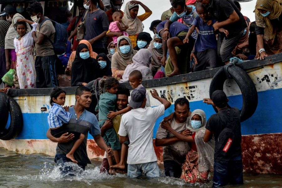 This photo taken on 25 June 2020 shows Rohingya emerging from a refugee boat at Lhokseumawe in North Aceh Regency, Indonesia. (Chaideer Mahyuddin/AFP)