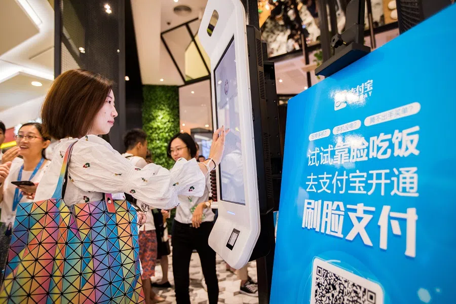 A Chinese customer experiences a facial recognition payment system, also known as the "Smile to Pay" system, at a KFC fast food restaurant in Hangzhou, Zhejiang province, China, on 1 September 2017. (STR/AFP)