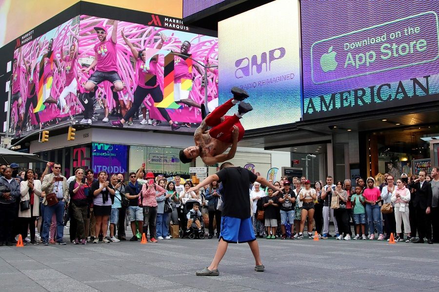 People watch street performers in Times Square, New York City, on 16 June 2023. (Leonardo Munoz/AFP)