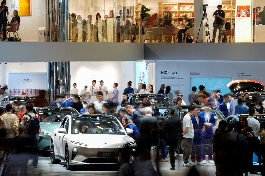 People visit at the Nio booth at the Auto Shanghai show, in Shanghai, China, 19 April 2023. (Aly Song/Reuters)