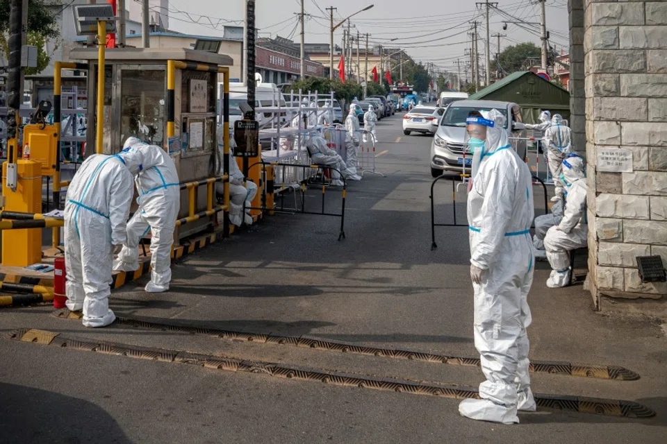 Workers wearing personal protective gear at an area placed under lockdown due to Covid-19 in Beijing, China, on 12 October 2022. (Bloomberg)