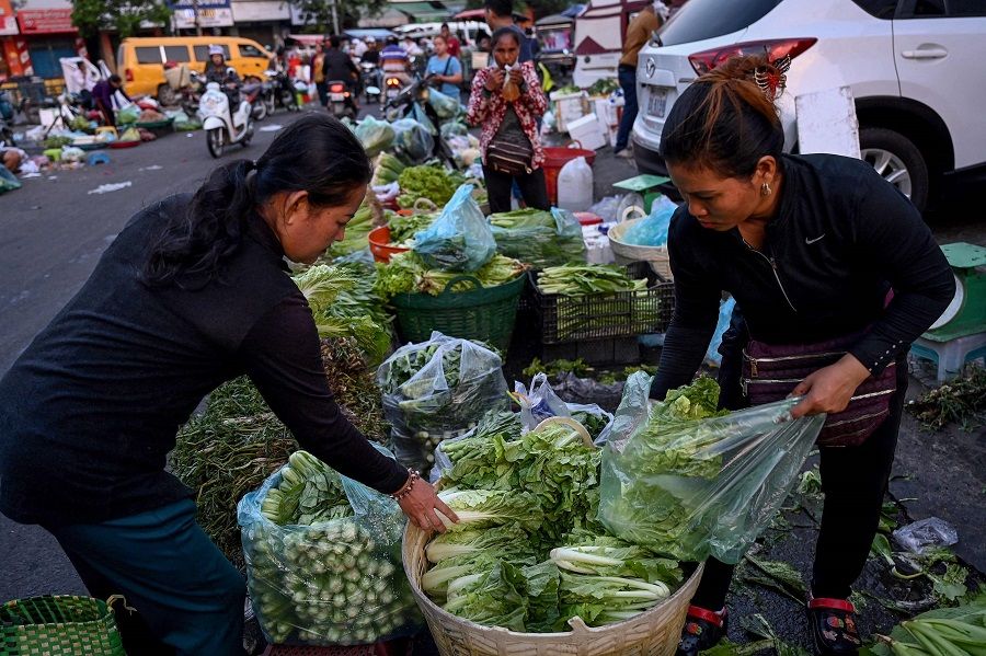 People at a market in Phnom Penh, Cambodia, on 2 March 2023. (Tang Chhin Sothy/AFP)