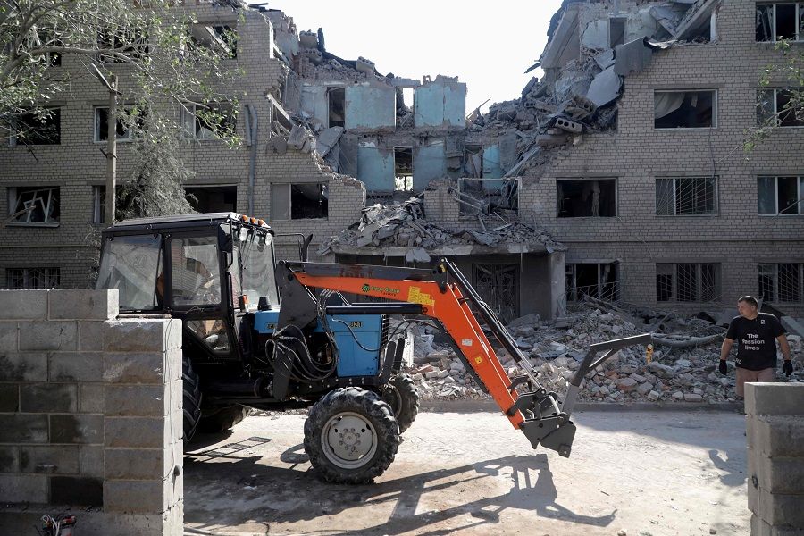 Communal workers remove the debris of a student hostel destroyed as a result of shelling in Mykolaiv, Ukraine, on 2 August 2022, amid Russia's military invasion launched on Ukraine. (Oleksandr Gimanov/AFP)
