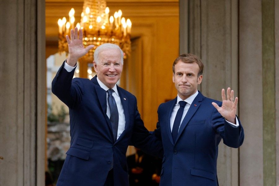 French President Emmanuel Macron (right) welcomes US President Joe Biden (left) before their meeting at the French embassy to the Vatican in Rome on 29 October 2021. (Ludovic Marin/AFP)