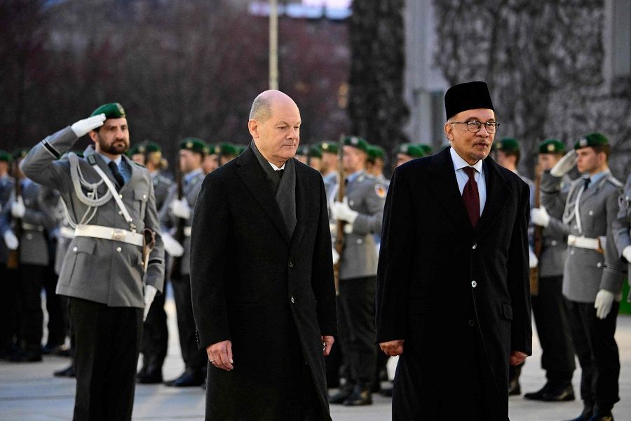 German Chancellor Olaf Scholz (left) and Malaysian Prime Minister Anwar Ibrahim review a military honour guard during an official welcoming ceremony prior to talks at the Chancellery in Berlin on 11 March 2024. (Tobias Schwarz/AFP)