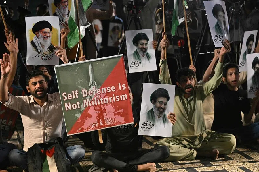 Shiite Muslims hold portraits of Iran's supreme leaders, Ali Hosseini Khamenei and his son Mojtaba Khamenei as they celebrate after the US and Iran agreed to a two-week ceasefire in Karachi on late 8 April 2026. (Asif Hassan/AFP)