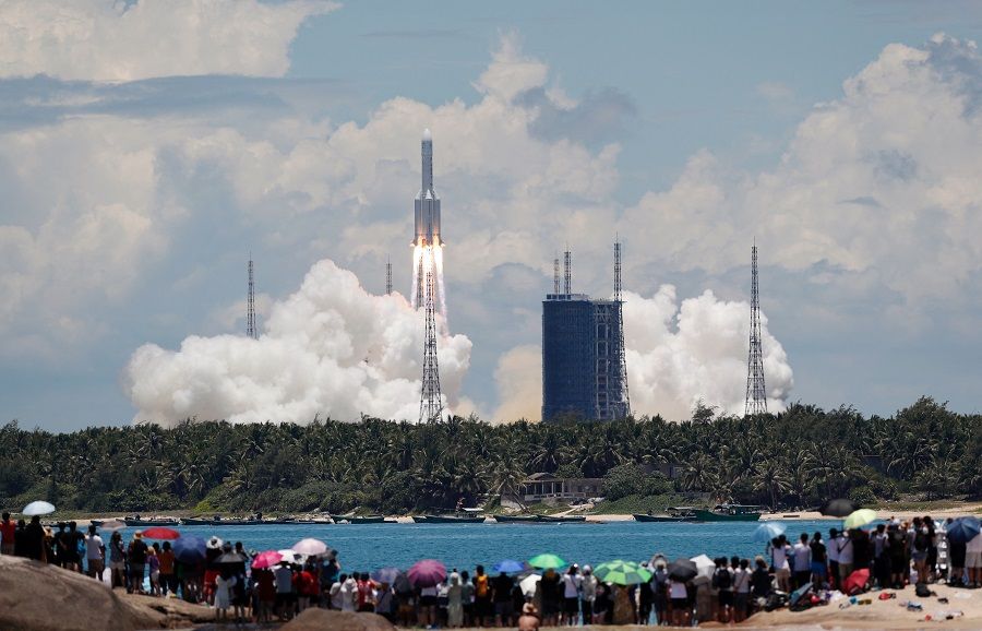 People watch from a beach as the Long March 5 Y-4 rocket, carrying an unmanned Mars probe of the Tianwen-1 mission, takes off from Wenchang Space Launch Center in Wenchang, Hainan province, China, on 23 July 2020. (China Daily via Reuters)
