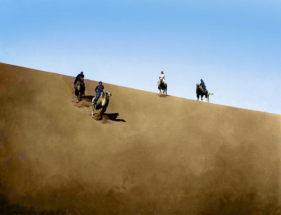 Central Asia, 1930s. Four camel riders traverse the vast desert, members of the Sino-Swedish Expedition (1927-1935) consisting of academics from China and Sweden, led by Sven Hedin. The deserts of Central Asia were on the land Silk Road.