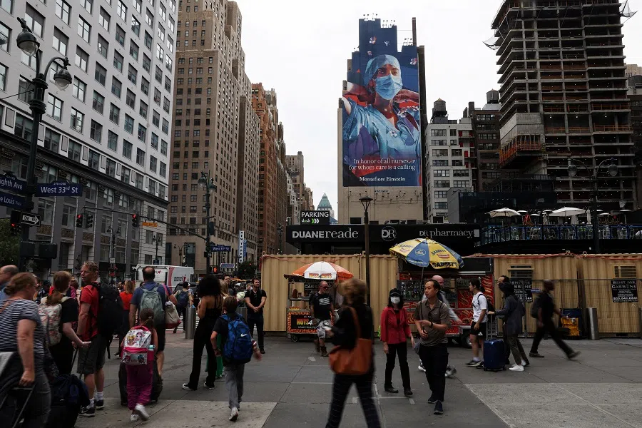 People walk on the corner of 34th street and 8th avenue outside Pennsylvania Station in New York City, US, 16 June 2023. (Shannon Stapleton/File Photo/Reuters)
