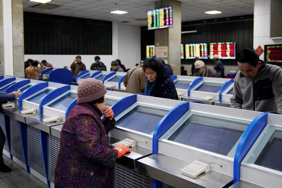 Investors look at computer screens showing stock information at a brokerage house in Shanghai, January 2020. (Aly Song/Reuters)