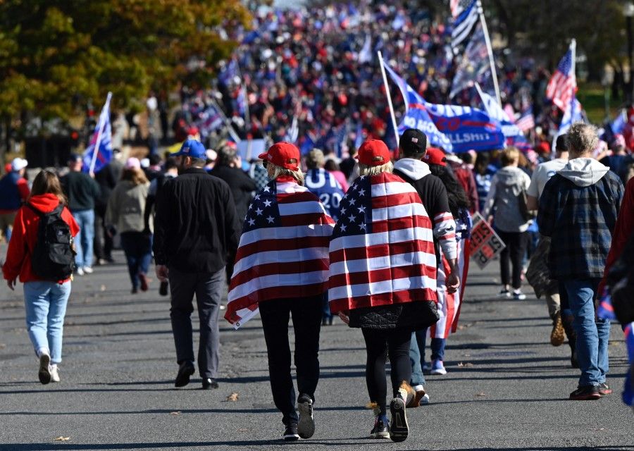 In this file photo taken on 14 November 2020, people take part in a rally in Washington, DC, claiming that the US presidential election on 3 November 2020 was fraudulent. (Andrew Caballero-Reynolds/AFP)
