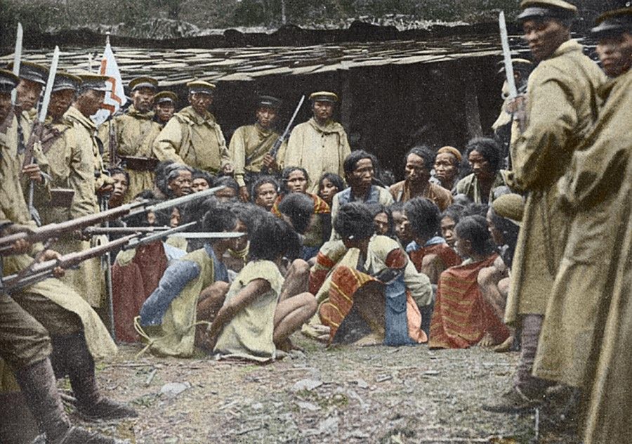 In 1914, after the Japanese army violently suppressed the resistance movement by the indigenous Taiwanese, they gathered the survivors and pointed their bayonets at their captives as instructed by the Japanese army photographer, facing the camera in a pose of victors.