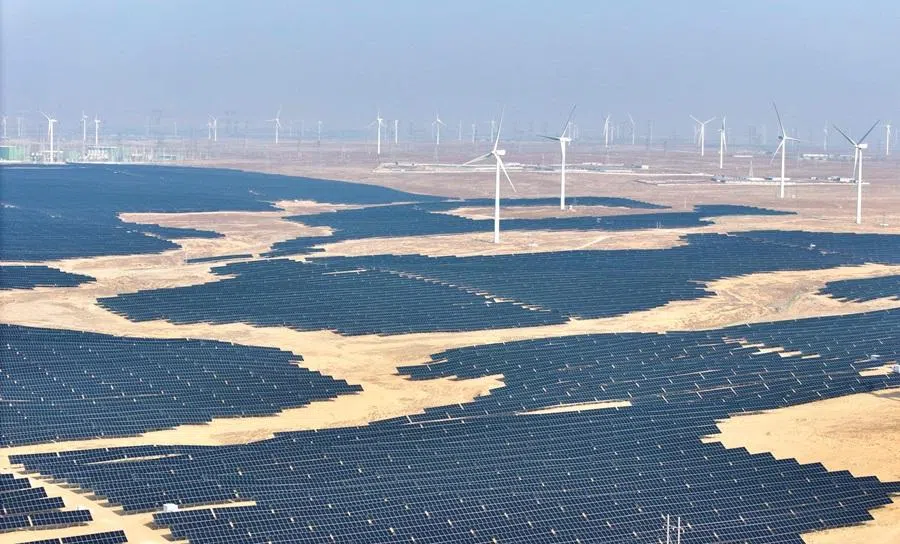 This picture taken on 22 December 2025 shows solar panels and wind turbines at a renewable energy farm in Lingwu, in China's Ningxia region. (AFP)