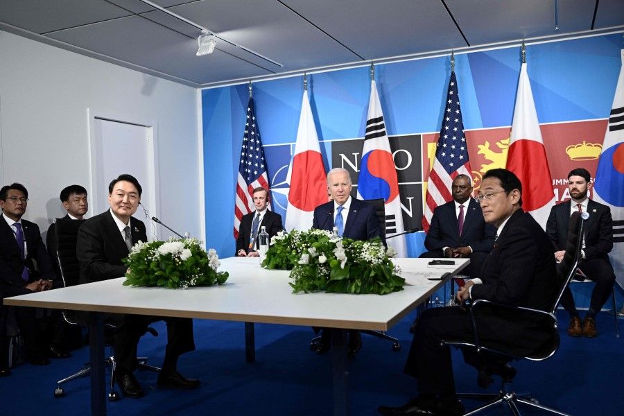 US President Joe Biden (centre) sits with South Korea's President Yoon Suk-Yeol (left) and Japan's Prime Minister Fumio Kishida (right) during a trilateral meeting on the sidelines of the NATO summit at the Ifema congress centre in Madrid, on 29 June 2022. (Brendan Smialowski/AFP)