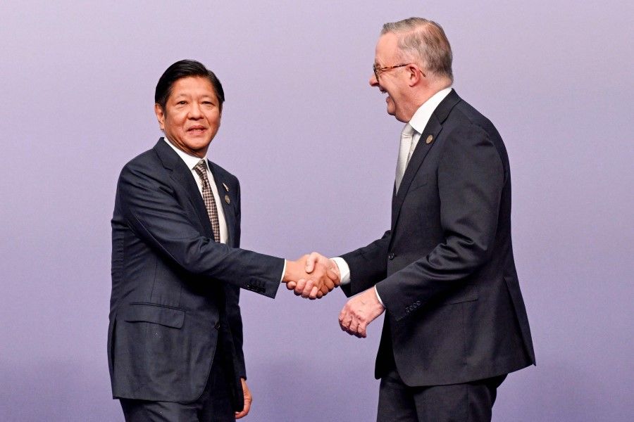 Australia's Prime Minister Anthony Albanese (right) shakes hands with Philippines' President Ferdinand Marcos Jr ahead of the family photo during the 50th ASEAN-Australia Special Summit in Melbourne on 5 March 2024. (William West/AFP)