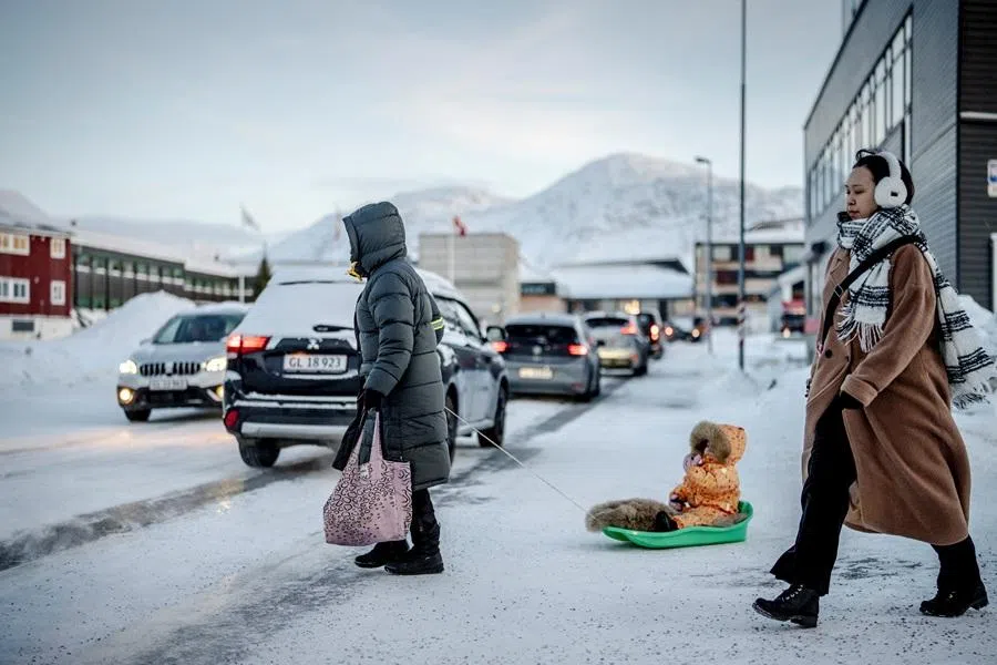 A person pulls a child on a snow sled, in Nuuk, Greenland, on 20 January 2026. (Mads Claus Rasmussen/Ritzau Scanpix via AFP)