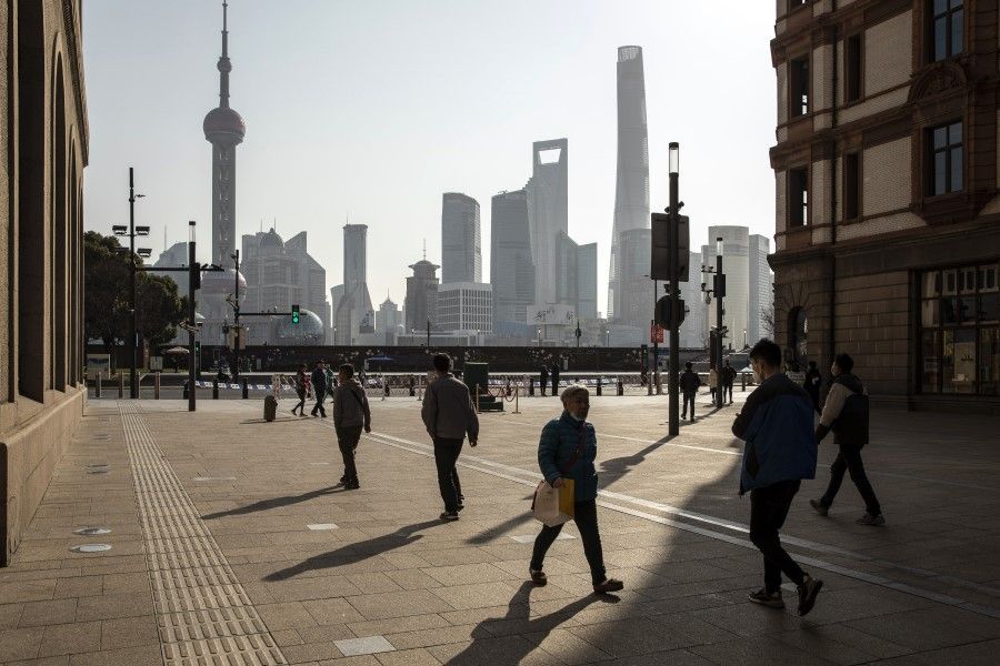 Pedestrians along Nanjing Road near the Bund in Shanghai, China, on 27 February 2022. (Qilai Shen/Bloomberg)