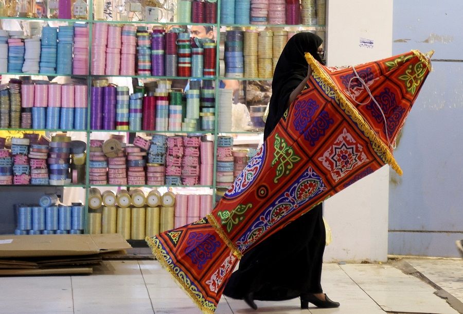 A Saudi woman shops for Ramadan decorations to mark the beginning of the Holy Month of Ramadan in a local market in Riyadh, Saudi Arabia, 22 March 2023. (Ahmed Yosri/Reuters)