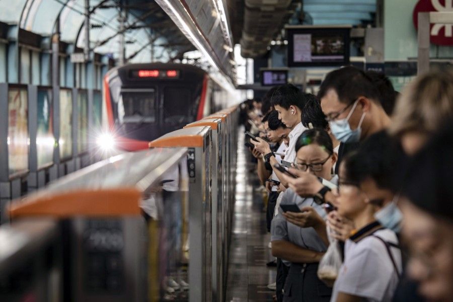 Commuters wait for a subway train at a Shenzhen Metro station in Shenzhen, China, on 9 August 2023. (Qilai Shen/Bloomberg)