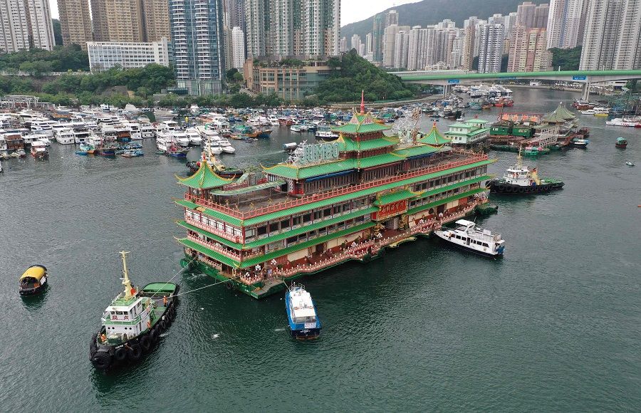 This file photo taken on 14 June 2022 shows an aerial view of Hong Kong's Jumbo Floating Restaurant being towed out of Aberdeen Harbour. (Peter Parks/AFP)