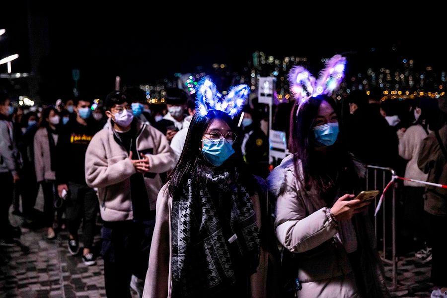 People wearing light headsets gather at Victoria Harbour, Hong Kong, on 31 December 2020. (Isaac Lawrence/AFP)