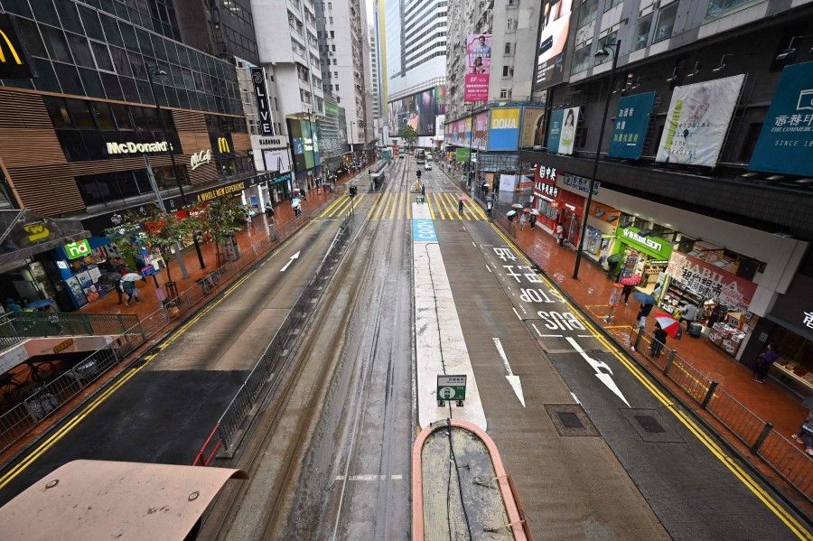 A usually busy street in Hong Kong's Causeway Bay district is seen empty on 21 February 2022, as the city faces its worst Covid-19 wave to date. (Peter Parks/AFP)