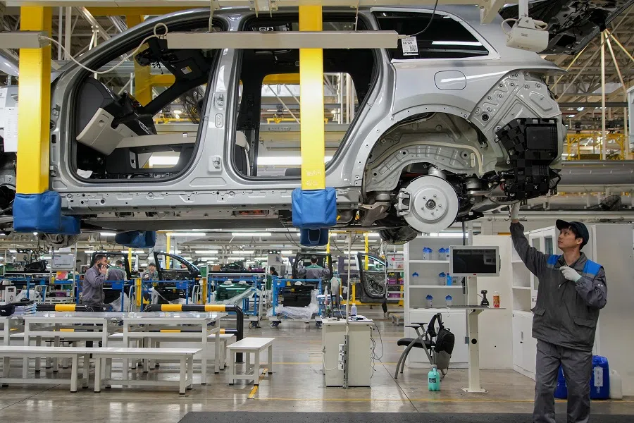 This photo taken on 27 March 2024 shows employees working on a car assembly line at a factory of Chinese carmaker Li Auto in Changzhou, Jiangsu province, China. 