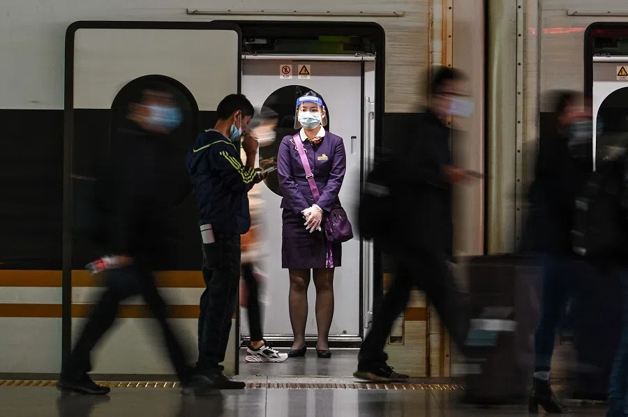 A staff member is seen on a train at the Hongqiao railway station in Shanghai, China, on 20 October 2021. (Hector Retamal/AFP)