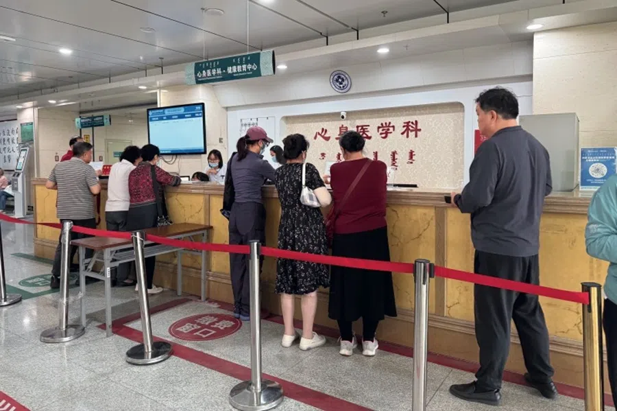 Patients line up at the consultation and payment counter of the psychosomatic medicine department at the Inner Mongolia International Mongolian Hospital in Hohhot on 9 June 2025. (Fan Qiaojia/Caixin)